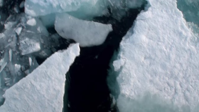 Icebreaker breaks the ice and move forward in Arctic. Fantastic wonderful amazing video grenland nature iceland. Lovely shooting the life of nature, seaside and mountains. Global warming.