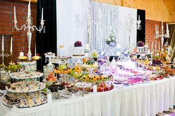 Elegance wedding reception table with food and decor.