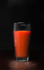 Tomato juice on a wooden table