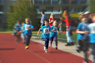 Fototapeta na wymiar Young preschool children, running on track in a marathon competi