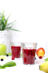 Berry smoothie with ingredients on marble