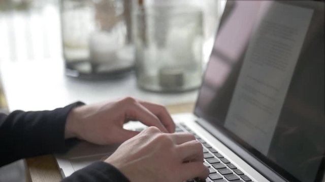 Cinemagraph of a businness / office man typing and working on a laptop computer. Only the reflection is moving. This is a seamless loop that is perfectly loopable. Moving photo / picture.
