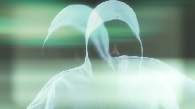 Slow motion of an angry hooded tomboy gesturing against a black background

