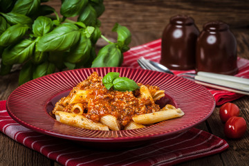 Penne a bolognese on white plate.