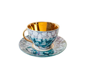 Vintage teacup and saucer in blue isolated on white