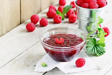 Homemade raspberry jam and fresh raspberry . Rustic style.Selective focus