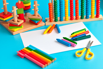 Colorful wooden toy building blocks toys on blue.