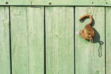 old rusty lock on a wooden door