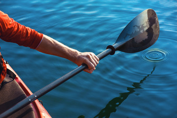man's hand with a paddle kayak - obrazy, fototapety, plakaty