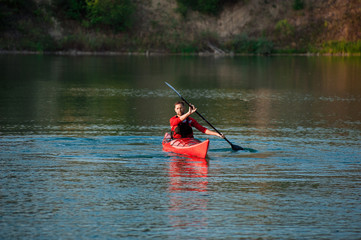 man kayaking on the lake sunset