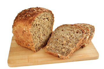 Loaf of brown whole grain bread with sunflower and sesame seeds sliced isolated on white background