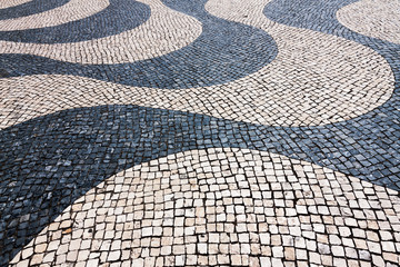 Typical cobblestone hand-made pavement iin Lisbon, Portugal