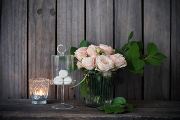 Elegant vintage wedding table decoration with roses and candles