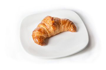Fresh croissant on white plate