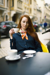 Ginger woman with coffee cup.