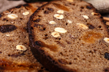 Sliced rye bread with prunes, dried apricots and hazelnut on old rustic table