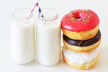 Assorted donuts and bottle of milk