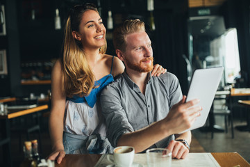 Beautiful couple looking at tablet
