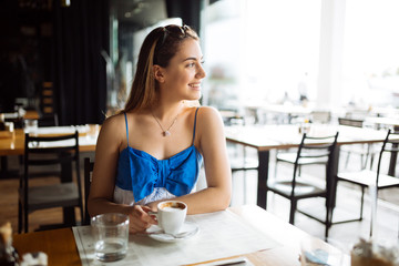 Woman drinking coffee in restaurant