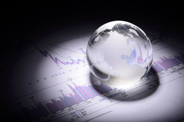 business concept of a glass globe on a trading chart