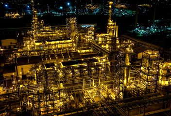 Pipes and buildings at big modern factory with lights