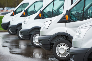 transporting service company. commercial delivery vans in row  - obrazy, fototapety, plakaty