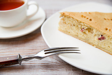 Cheese cake and a cup with a drink on the table