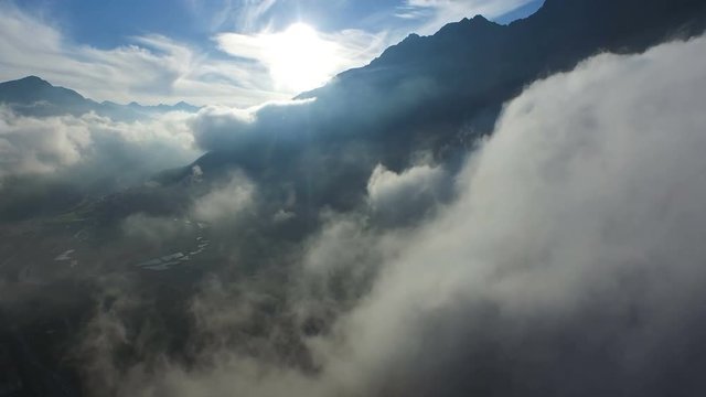 Aerial Footage: Flight near clouds during sunset in the alps, 4K, UHD