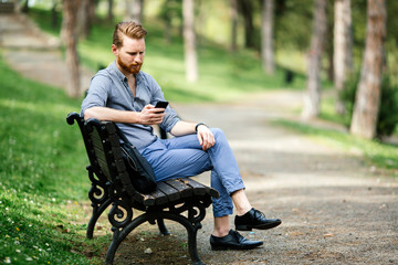 Fototapeta premium Handsome businessman using phone