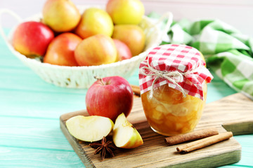 Apple jam in jar on a mint wooden table