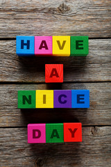 Colorful wooden toy cubes on a grey wooden background