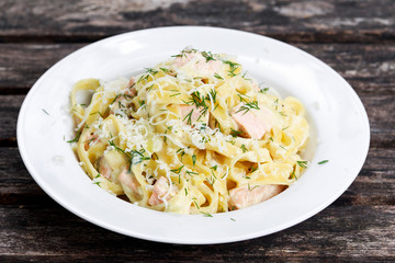 tasty pasta with salmon, dill on plate