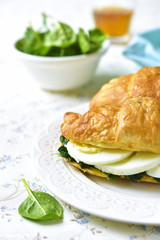 Croissant with spinach and boiled egg.