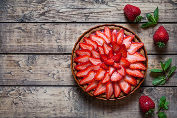 Strawberry tart with cream and mint traditional summer sweet pastry fruit dessert on vintage wooden table background - obrazy, fototapety, plakaty