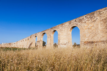 Fototapeta na wymiar Kamares Aqueduct, Bekir Pasha Aqueduct. Larnaca, Cyprus. Sunset panorama landscape