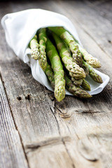  Delicious green asparagus on a wooden background 