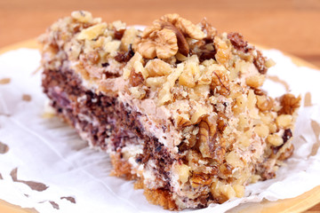 portion of white and brown chocolate walnut cake with walnuts
