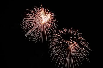 Two flashes of festive white fireworks.