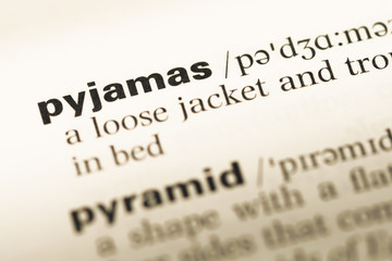 Fototapeta premium Close up of old English dictionary page with word pyjamas