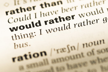 Close up of old English dictionary page with word would rather