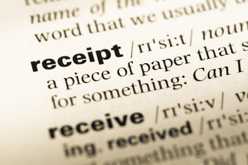 Fototapeta premium Close up of old English dictionary page with word receipt