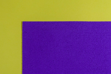 Fototapeta premium Eva foam ethylene vinyl acetate sponge plush purple surface on lemon yellow smooth background