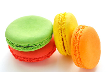 pile of colorful and tasty French Macarons on white background
