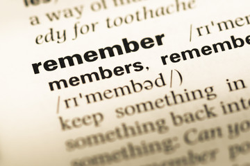 Fototapeta premium Close up of old English dictionary page with word remember