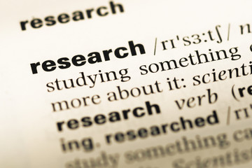 Close up of old English dictionary page with word research