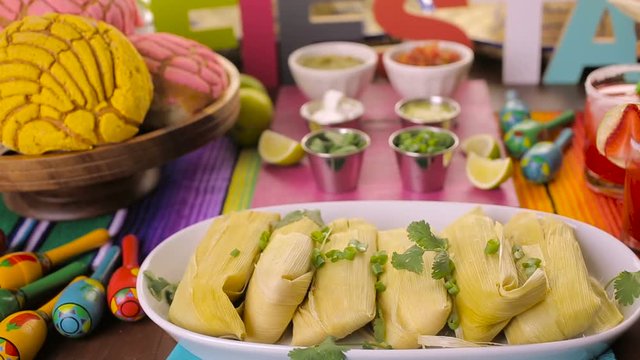 Party table with tamales, strawberry margaritas and pan dulche bread