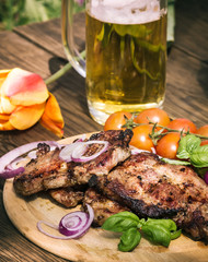 Grilled pork meat and glass of beer