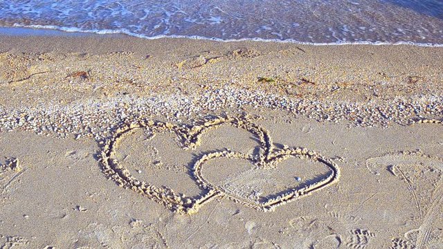 The loving hearts. Two hearts on the beach.
