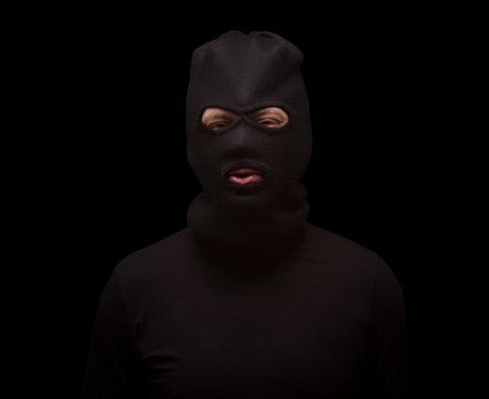 Masked thief on black