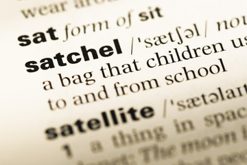 Fototapeta premium Close up of old English dictionary page with word satchel